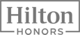 The image shows the logo for Hilton Honors, with "Hilton" in large text and "HONORS" below it, enclosed in a rectangular border.