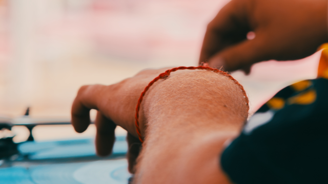 A person is using a turntable, adjusting the vinyl record with their hands.