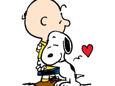 Charlie Brown hugs Snoopy with a small heart nearby, conveying affection and warmth in a cute cartoon moment.